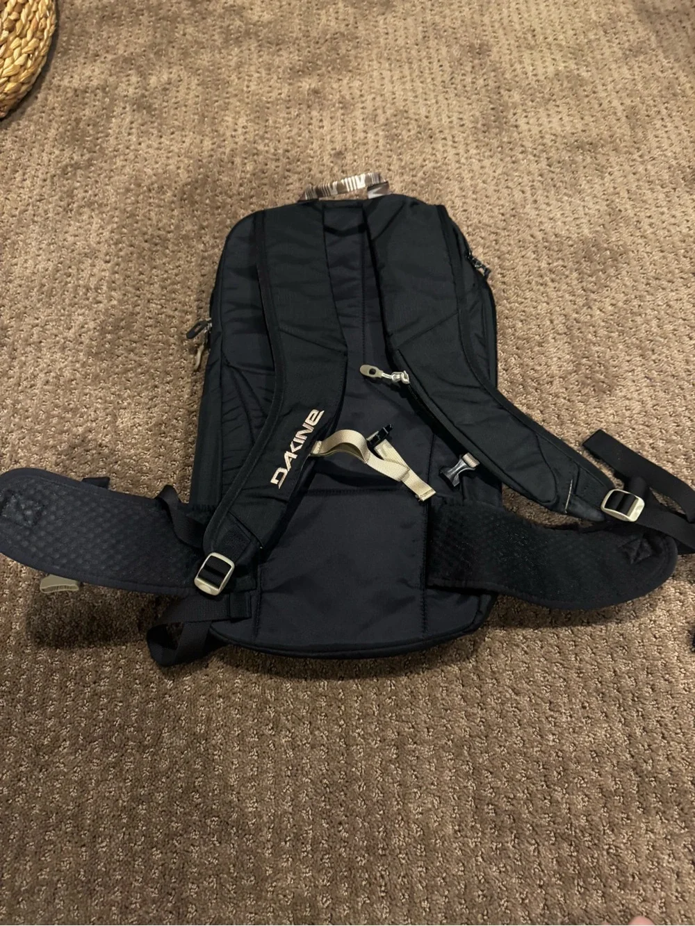 Dakine Black hydration Backpack with Tan Patterned Straps and hip straps